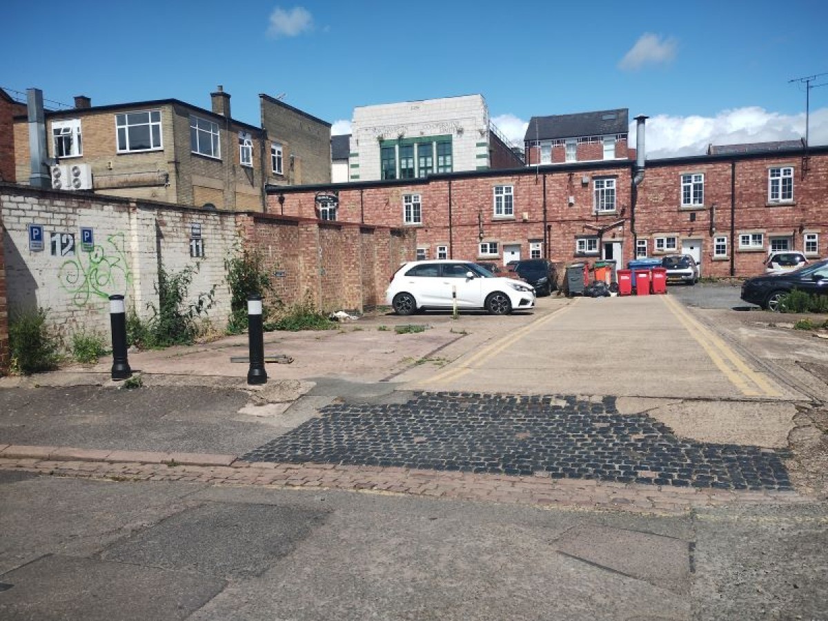 Outdoor shot of the Vulcan Works building, with the large black doors closed.